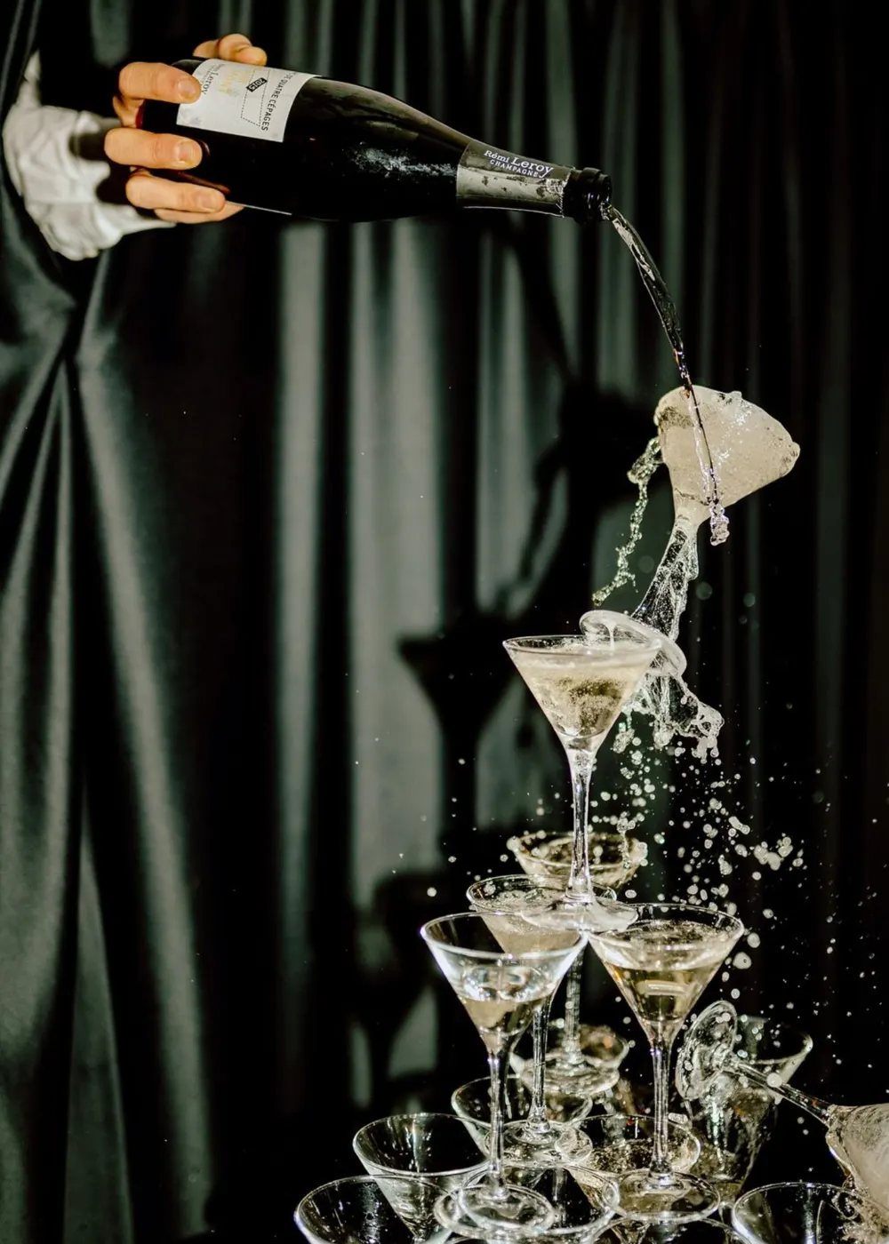 Champagne tower being poured at an event