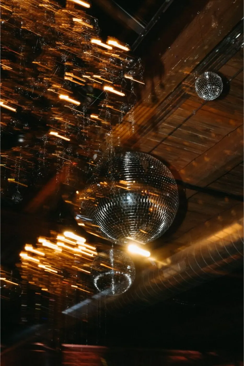 Disco balls hanging above a party