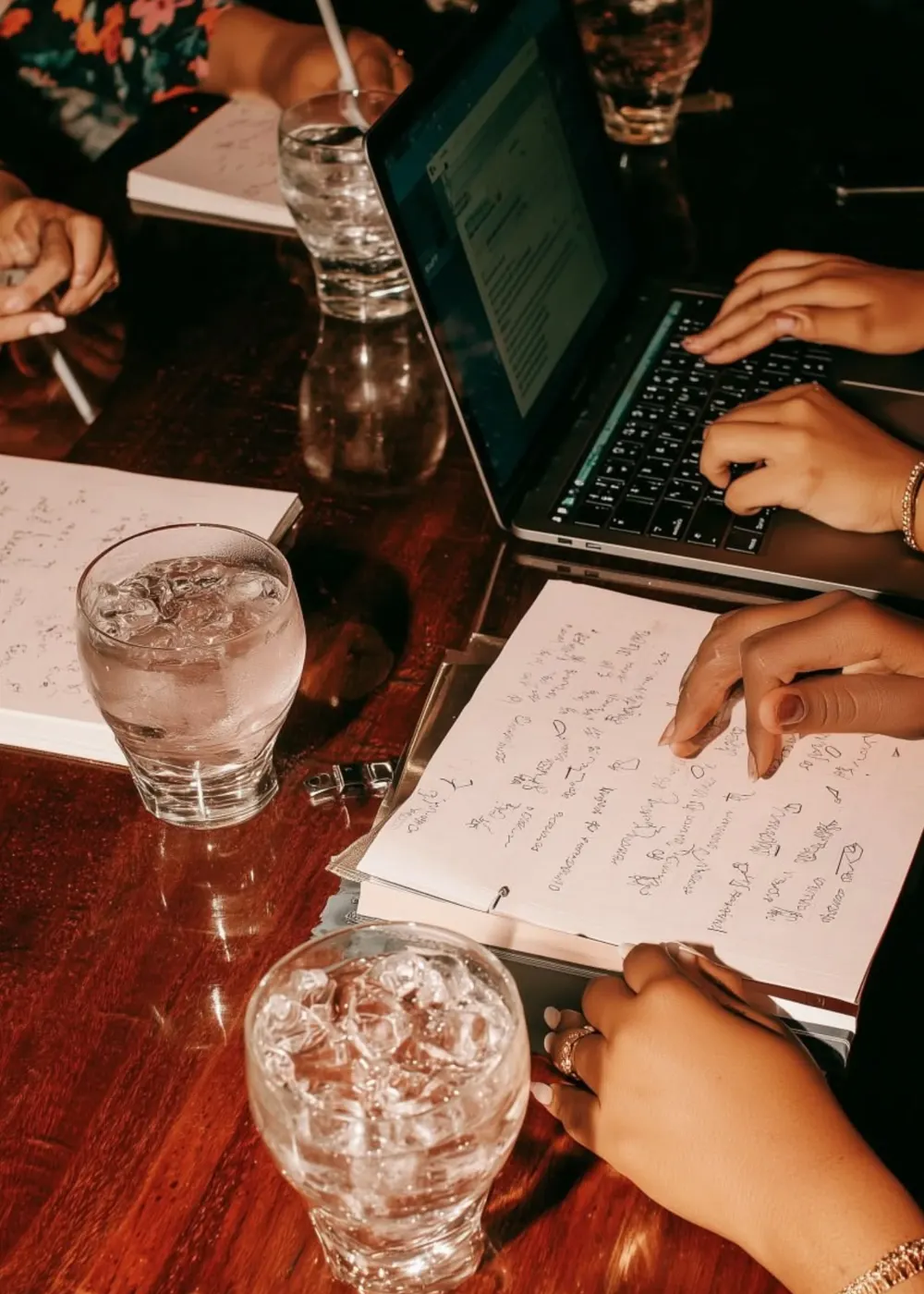 Planning a mobile bartending business with notebooks and a laptop